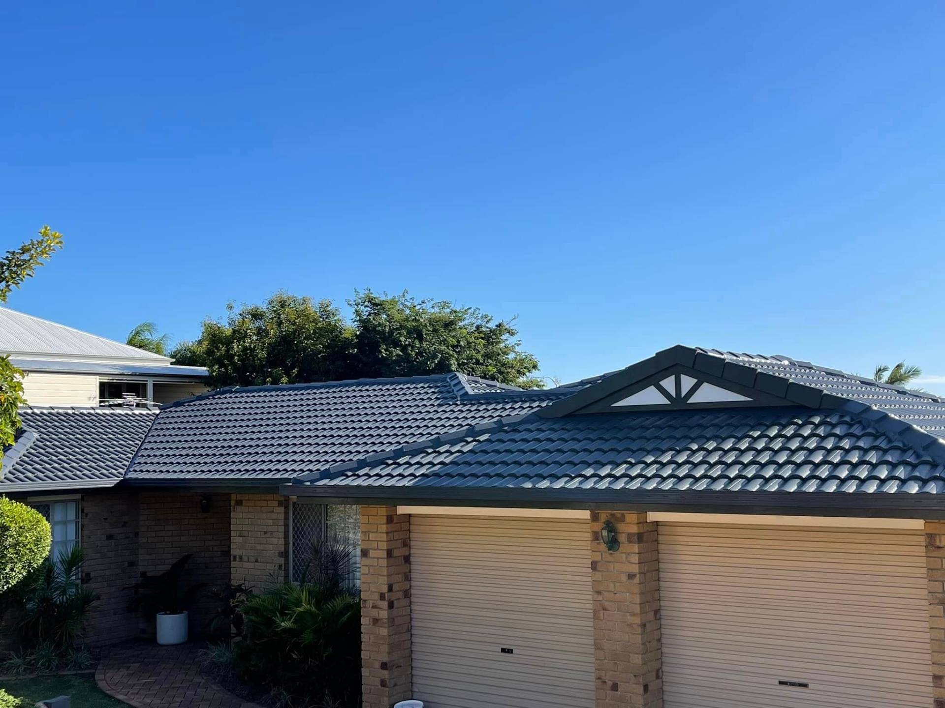 Tile roof restoration — terracotta to charcoal — after