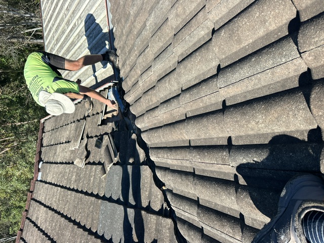 Pete's Painting team member repairing roof tiles in Brisbane