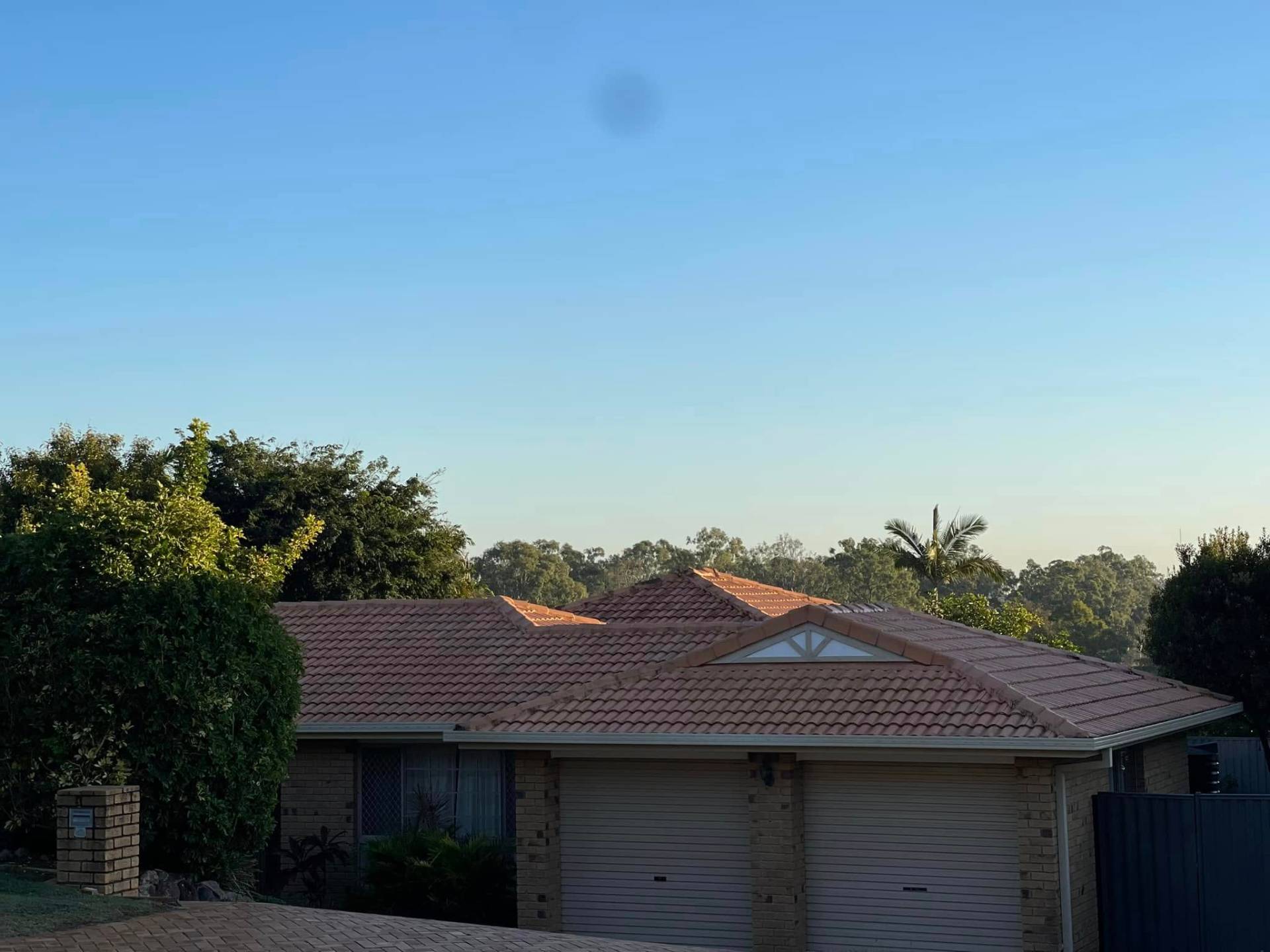 Tile roof restoration — terracotta to charcoal — before