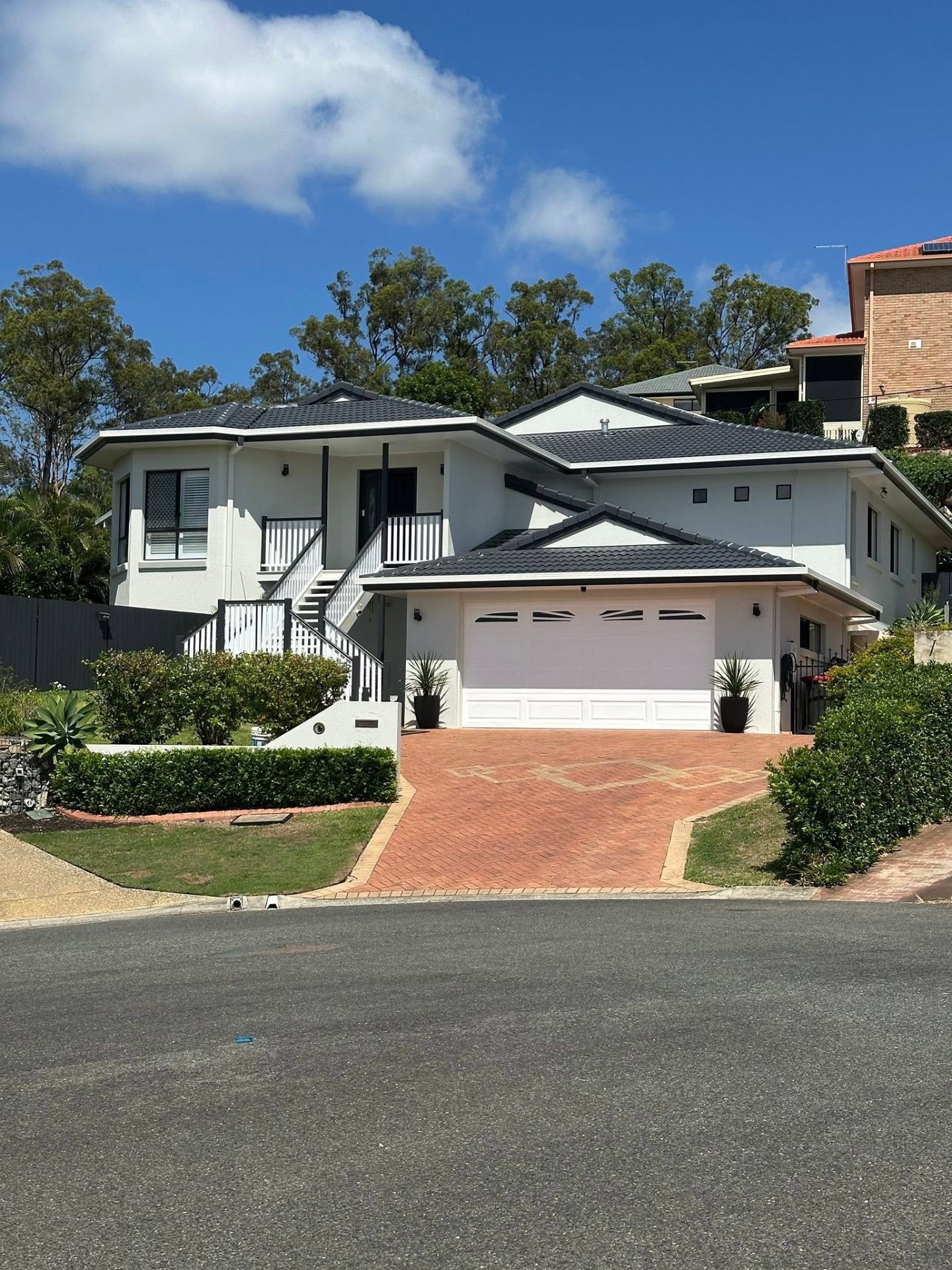 Professional painter freshening the exterior of a Brisbane home